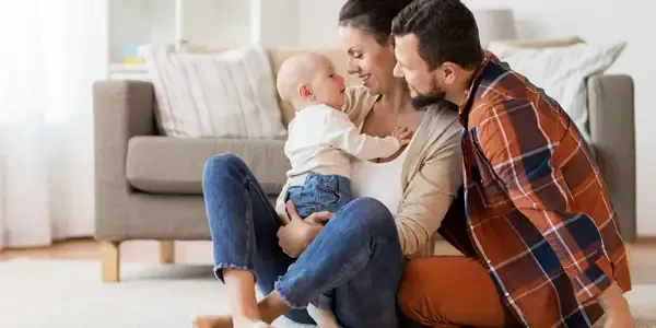 family laughing and playing in living room